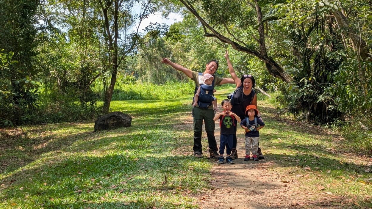 asian family of 5, with 3 young kids trekking in forest singapore