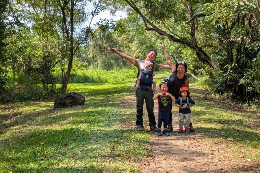 asian family of 5, with 3 young kids trekking in forest singapore